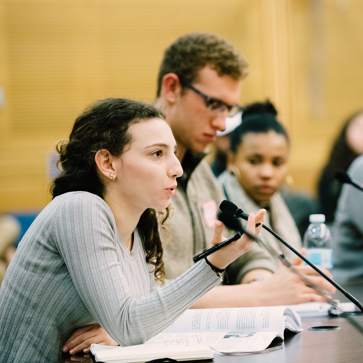 A Hillel student speaks into a microphone at a conference